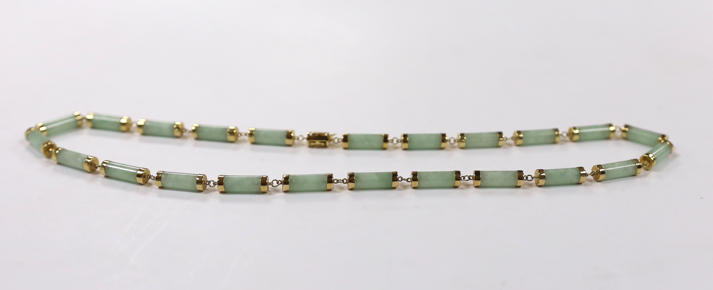 A Chinese 14k yellow metal and jade set baton link necklace, 45cm, gross weight 26.3 grams, together with a pair of 750 yellow metal and cabochon jade set ear studs, gross weight 2.2 grams.